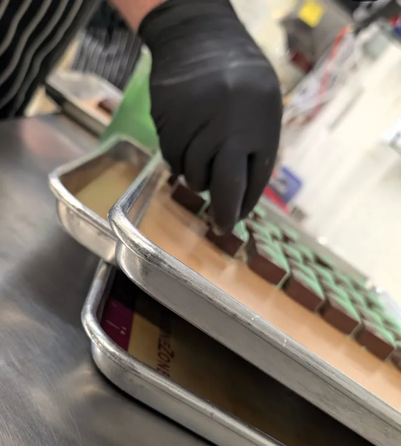 Chocolate edibles being prepared on trays