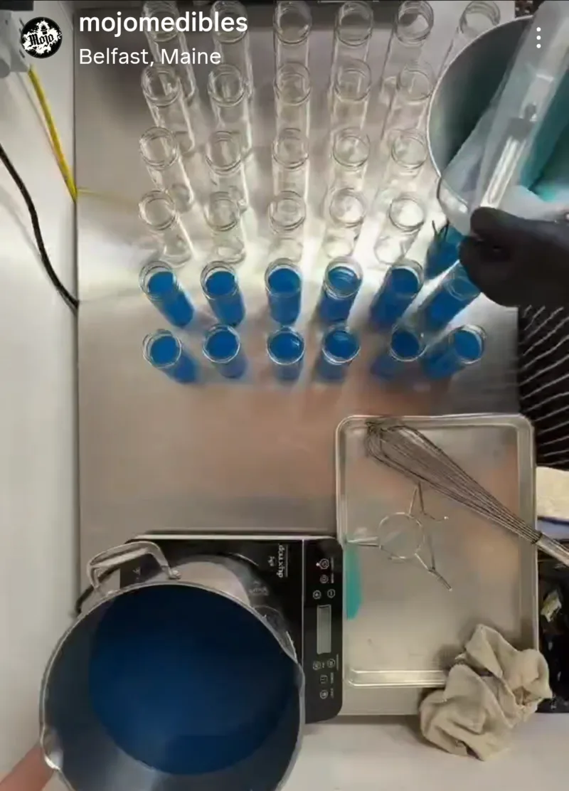 Blue liquid shots being filled in the Mojo kitchen